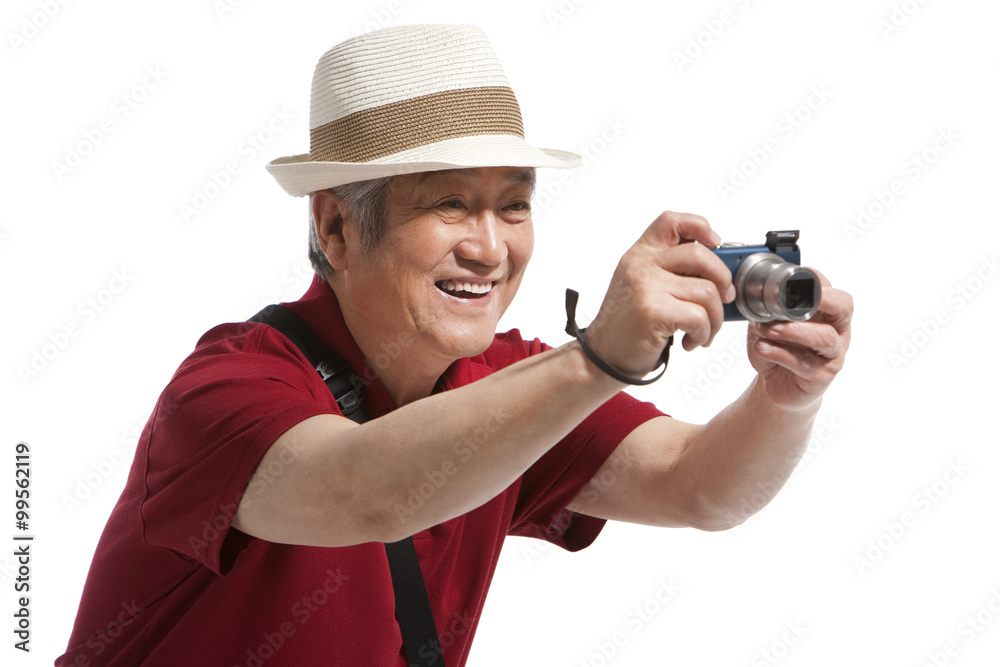 Portrait of senior man holding a camera