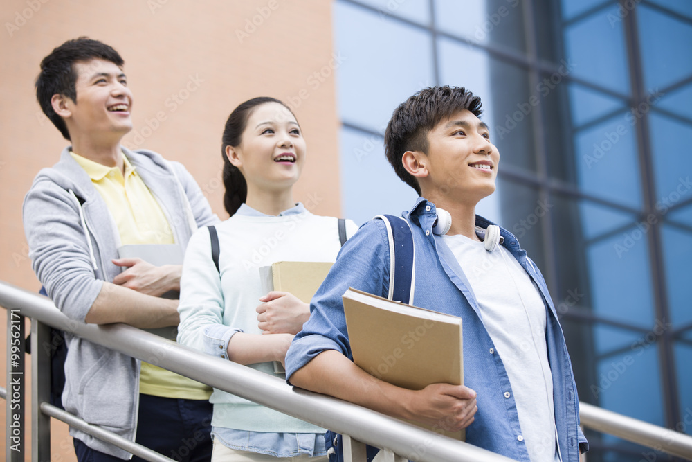 Young college students outside library