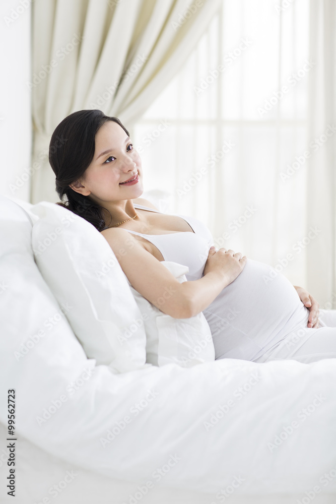 Pregnant woman resting in bed