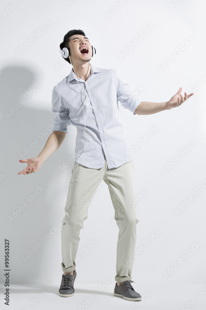 Happy young man listening to music