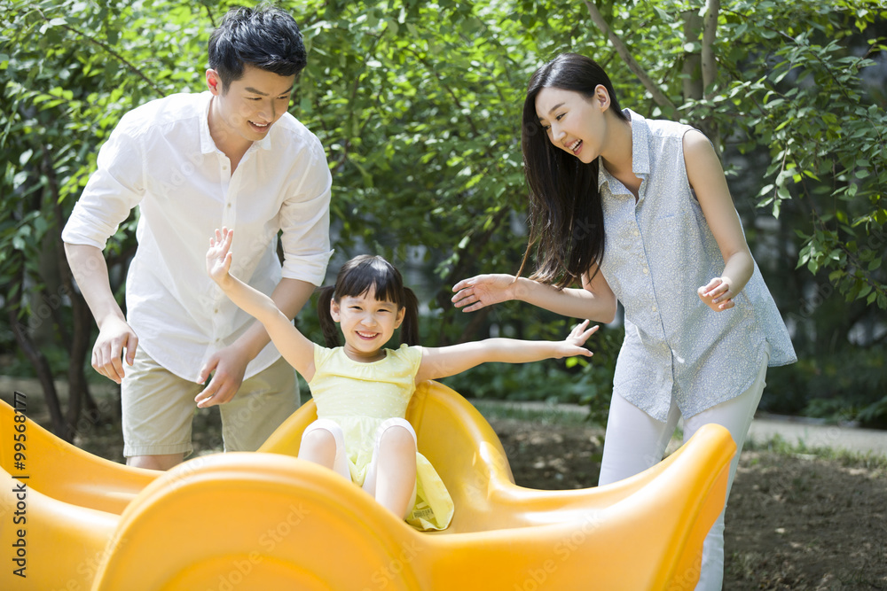 Young family playing in amusement park