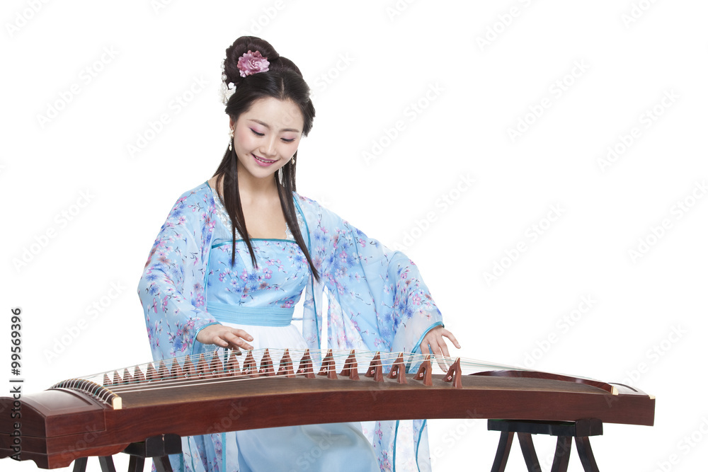 Young woman in Chinese traditional costume plucking Chinese zither