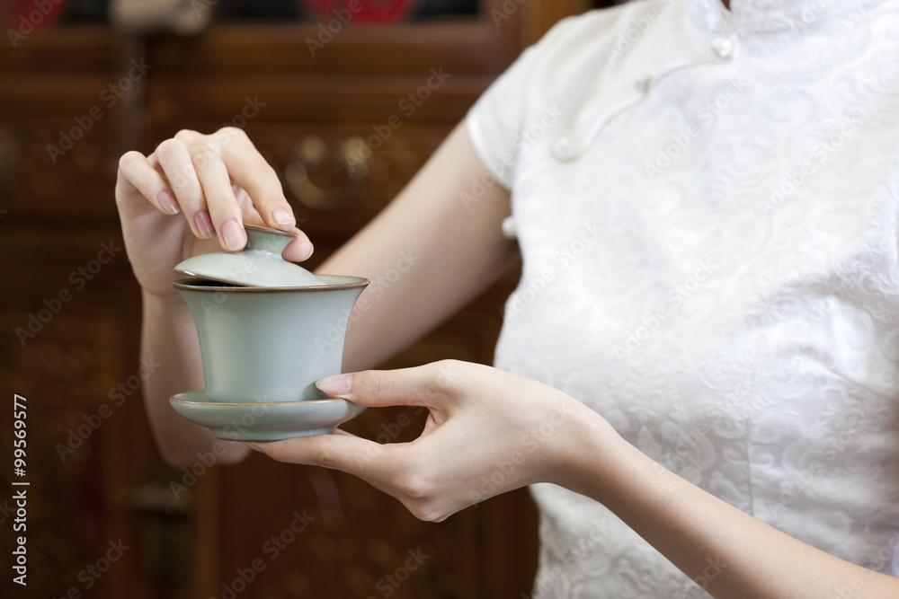 Young woman with a cup of Chinese tea