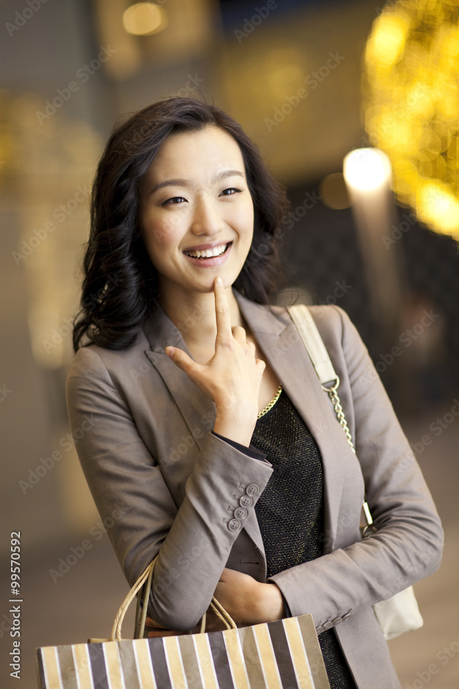 Cheerful young woman with shopping bags