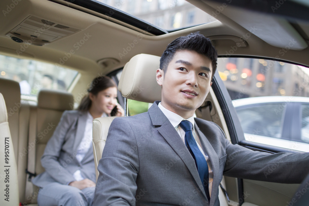 Chauffeur driving car for a businesswoman