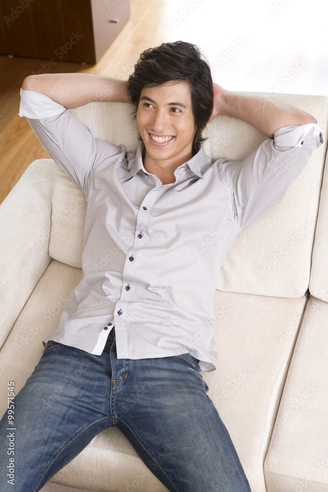 Asian man on sofa