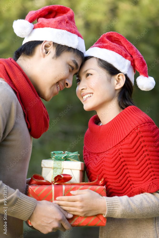 Young Couple Exchanging Christmas Gifts