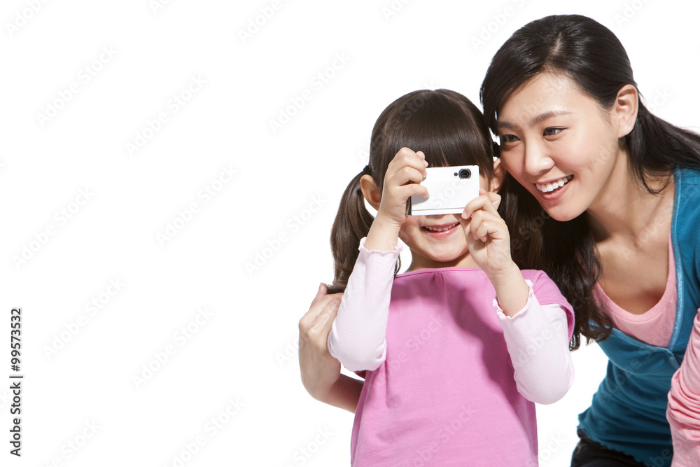 Happy mother and daughter holding a camera