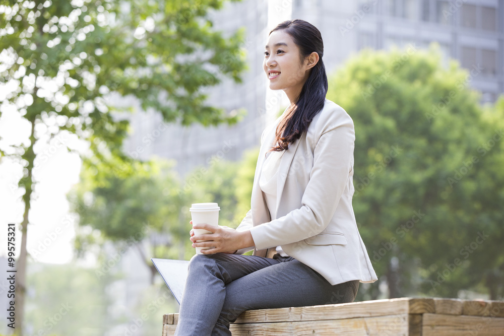 Young businesswoman with coffee cup