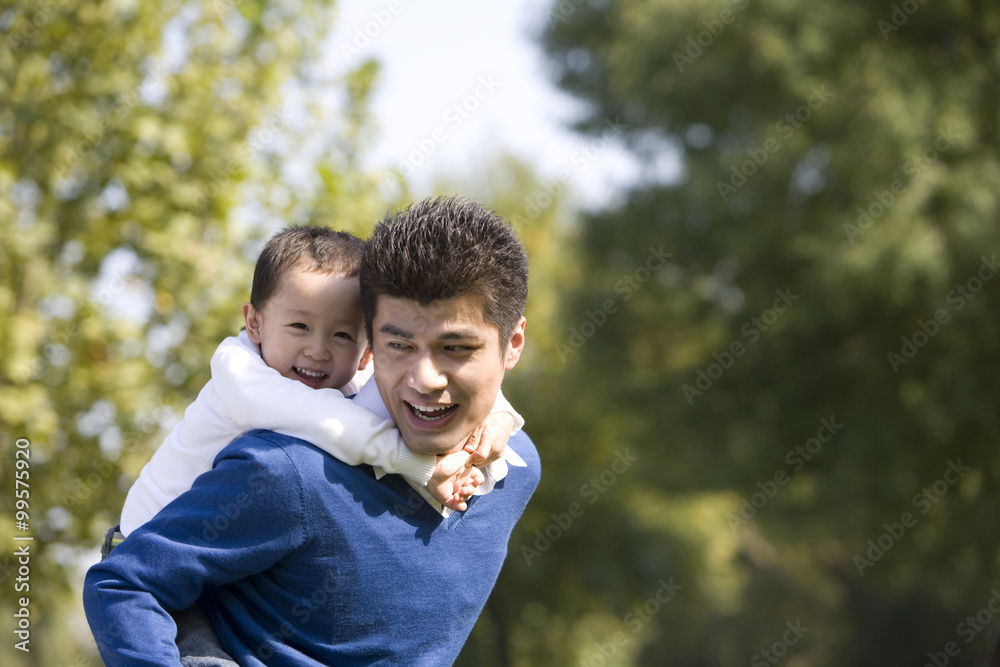 Portrait of father and son in the park