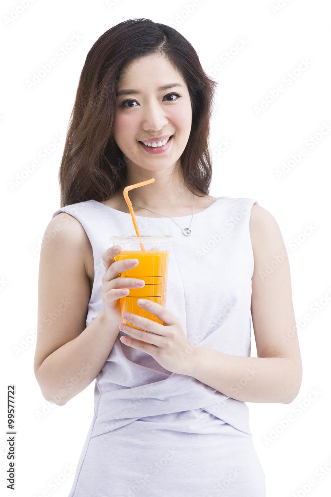 Portrait of beautiful young woman holding a cup of juice