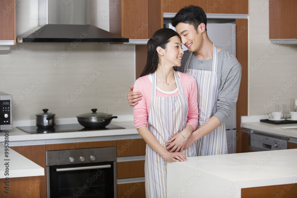 Happy young couple in kitchen