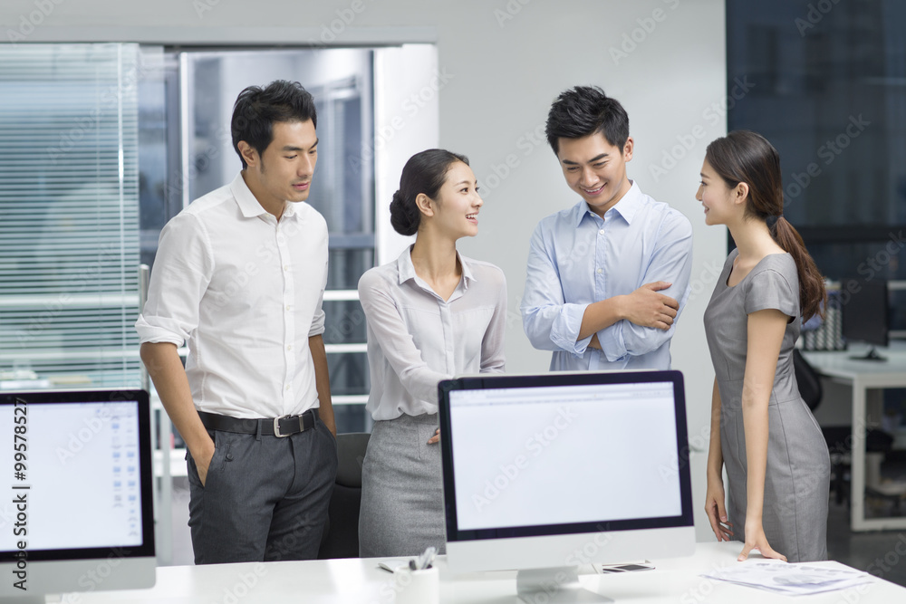 Young business people using computer in office