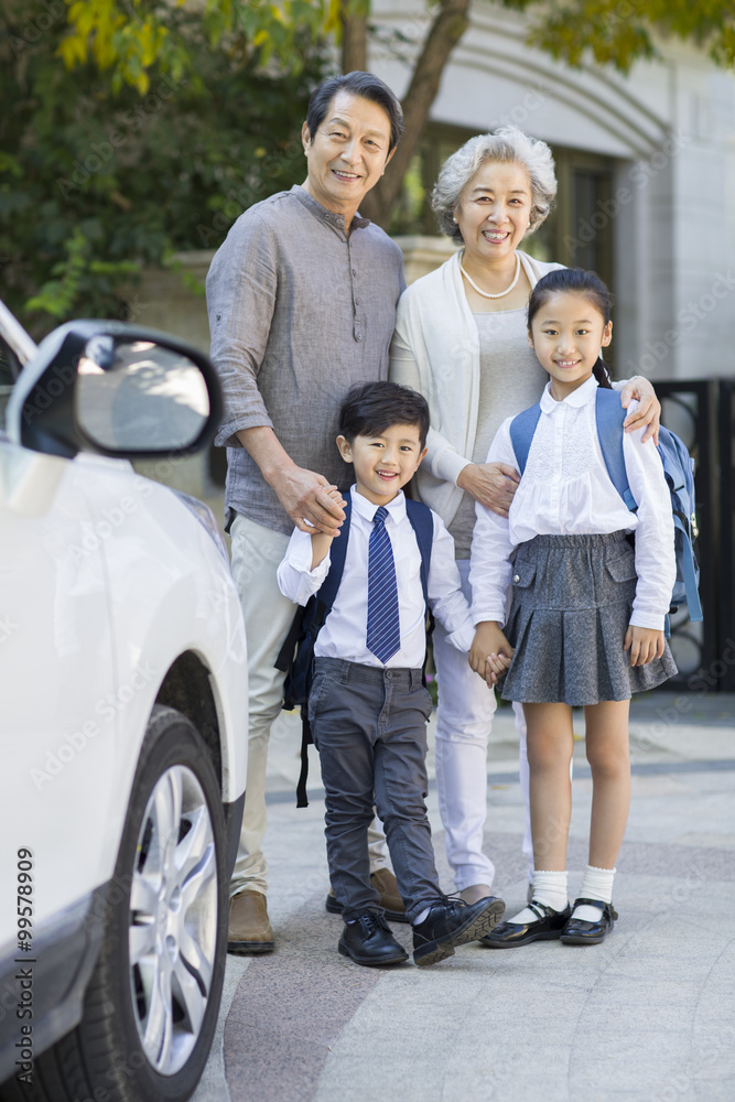 Portrait of senior couple and their grandchildren