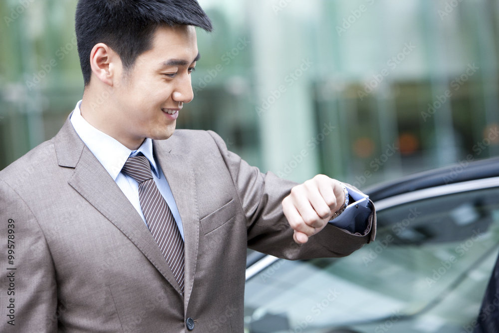 Young businessman checking time