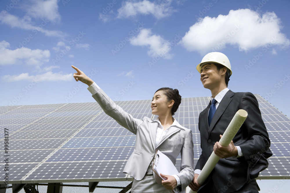 Two engineers in front of solar panels