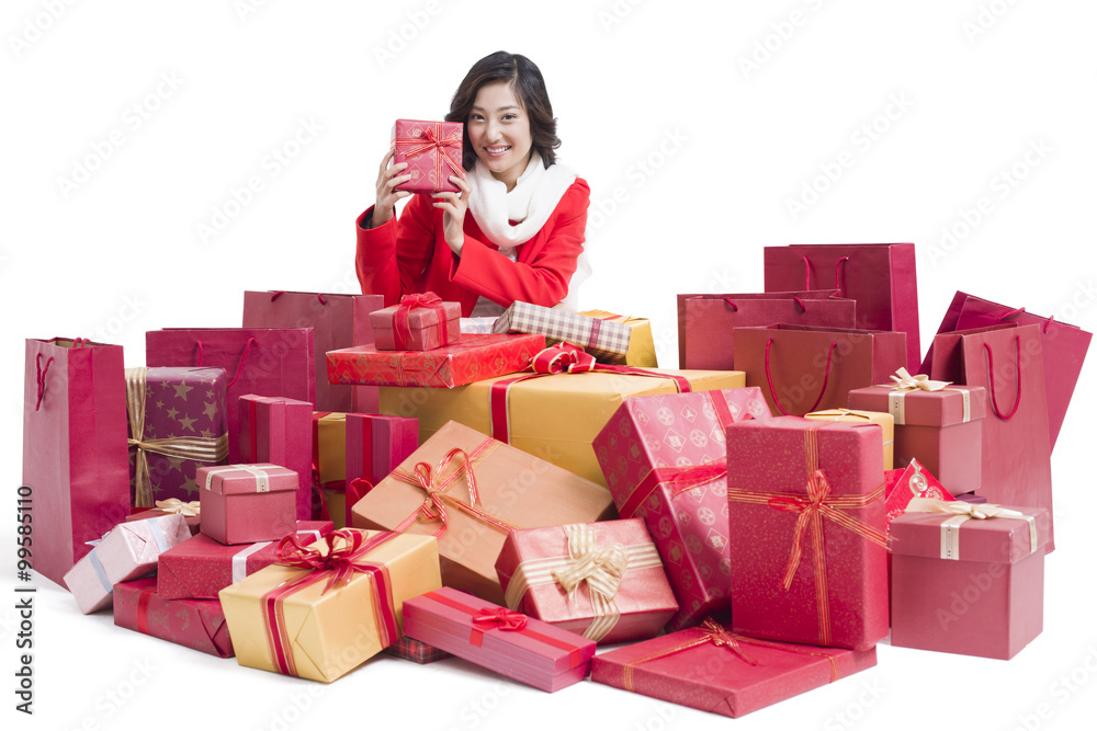 Happy young woman with many gifts