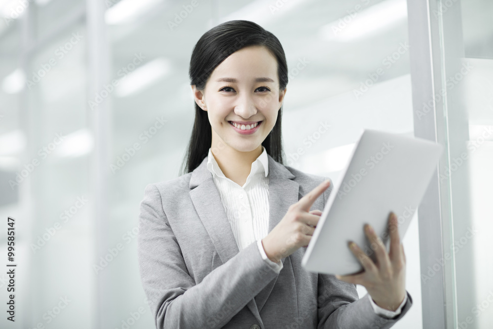 Young businesswoman with digital table