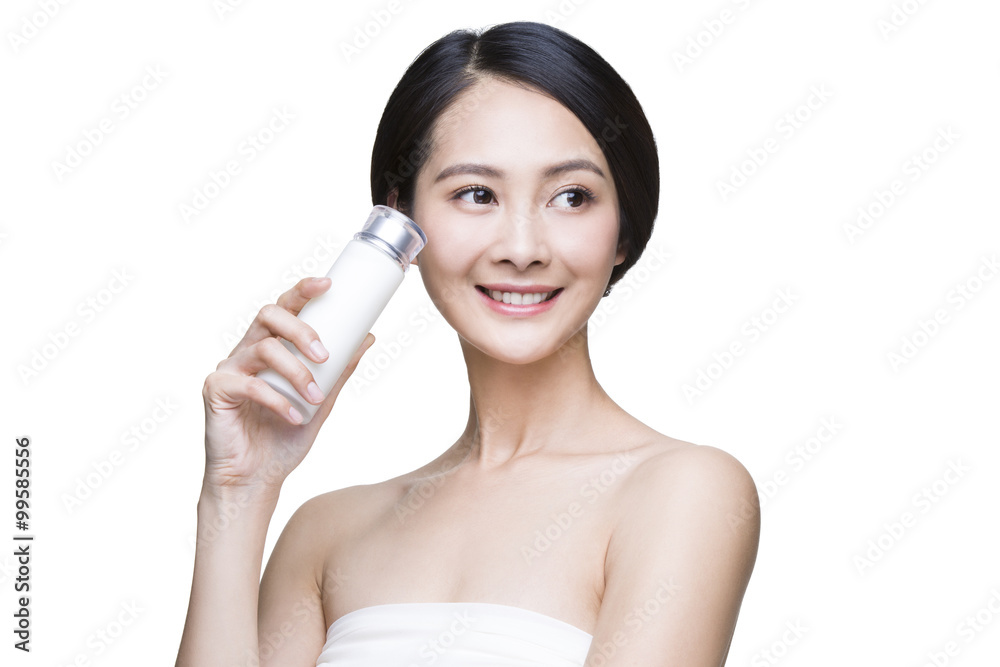 Beautiful young woman with cosmetic product