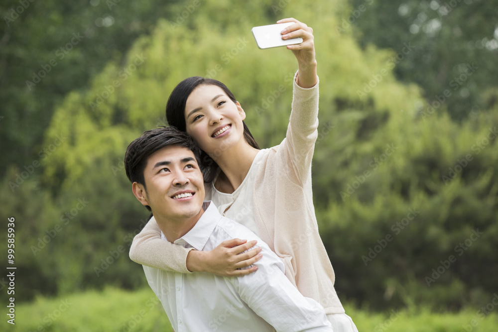 Young couple taking self portrait with smart phone