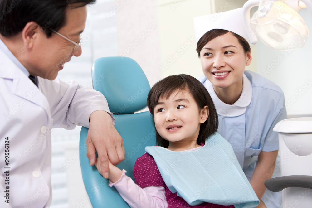 Little patient receiving treatment in dental clinic