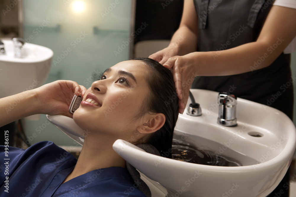 Woman At The Hairdresser Talking On Cellphone