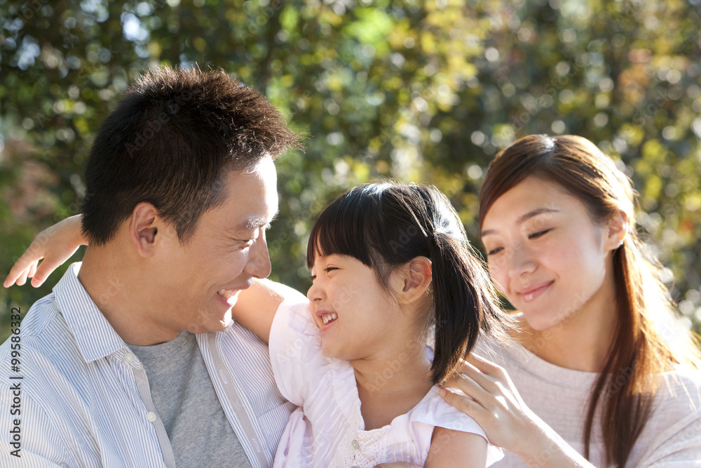 Young Chinese family in a park