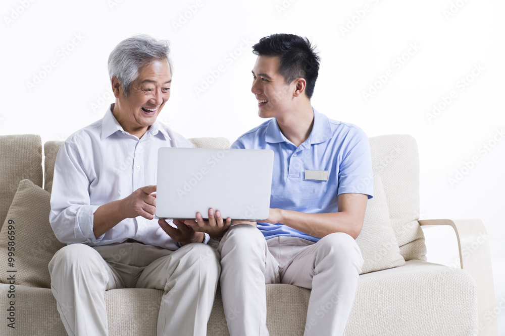 Male nursing worker and senior man surfing the net