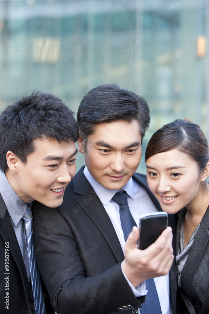 Business people looking at cellphone