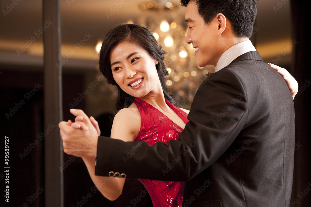 Young couple dancing in a luxurious room