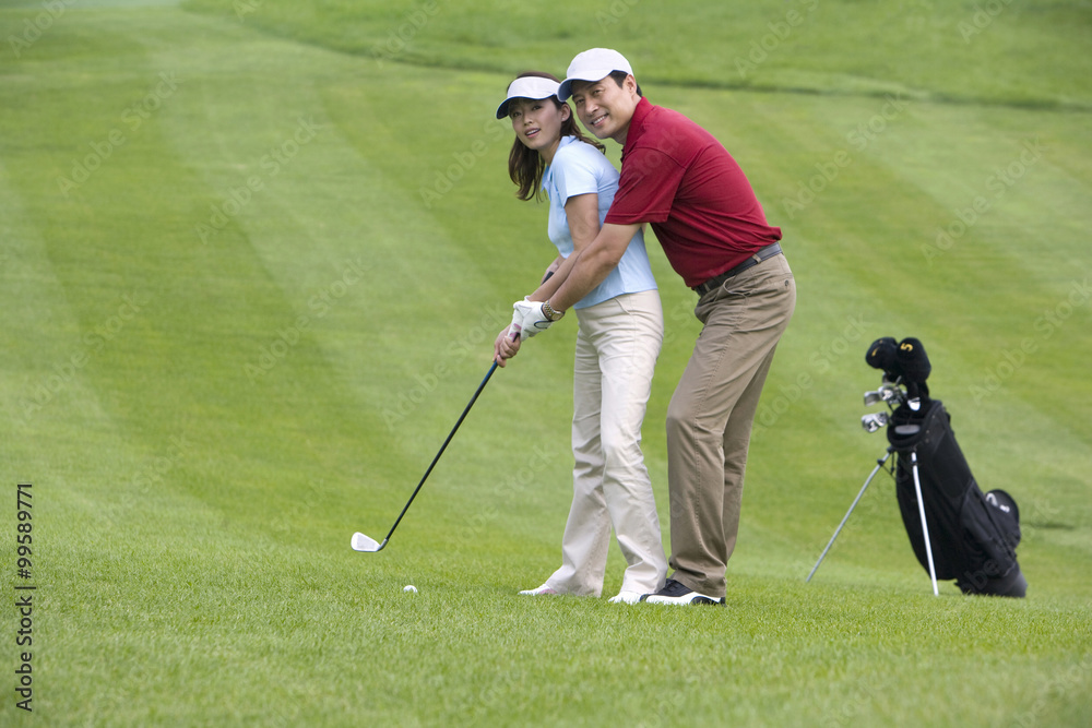 Golf coach teaching playing golf