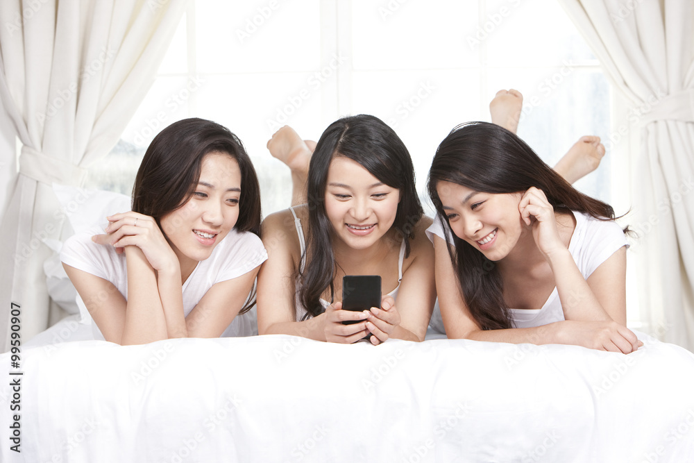 Best female friends using cellphone at home