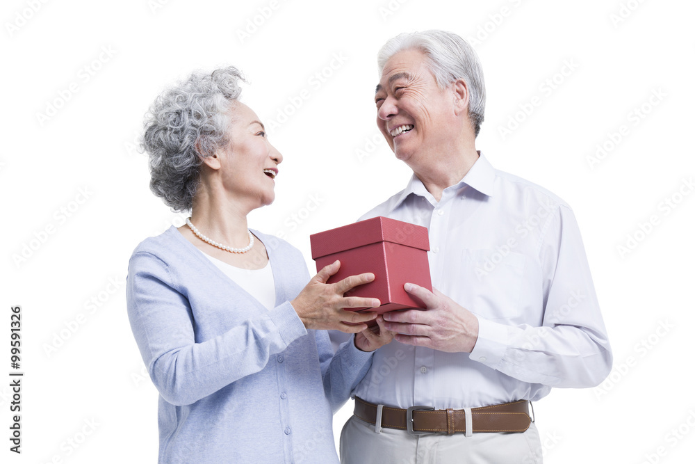 Happy senior couple with gift box