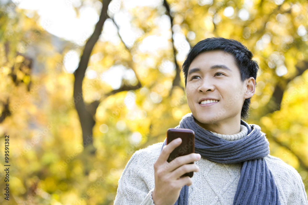 Young Man Texting on a Mobile Phone