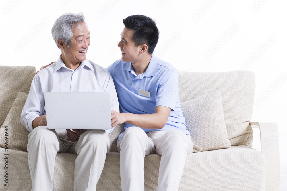 Male nursing worker and senior man surfing the net