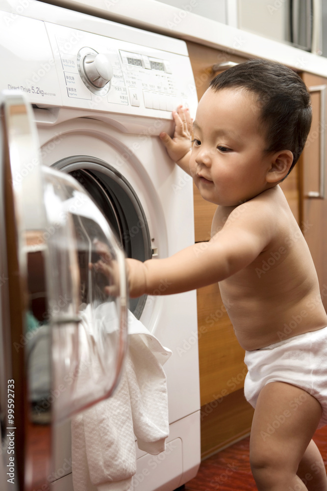 Infant with washing machine