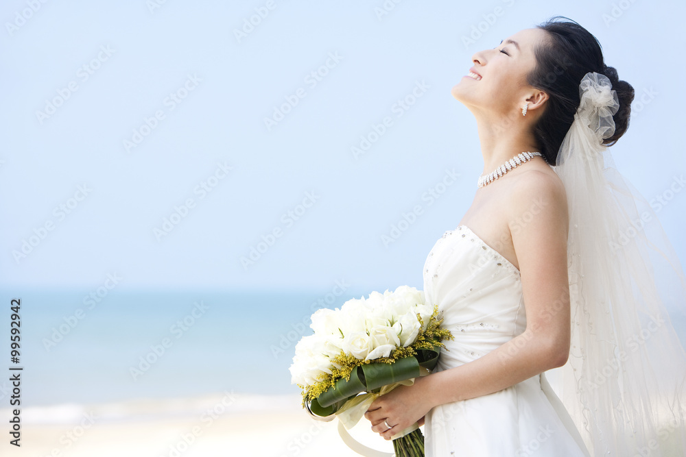 Happy bride relaxing on the beach