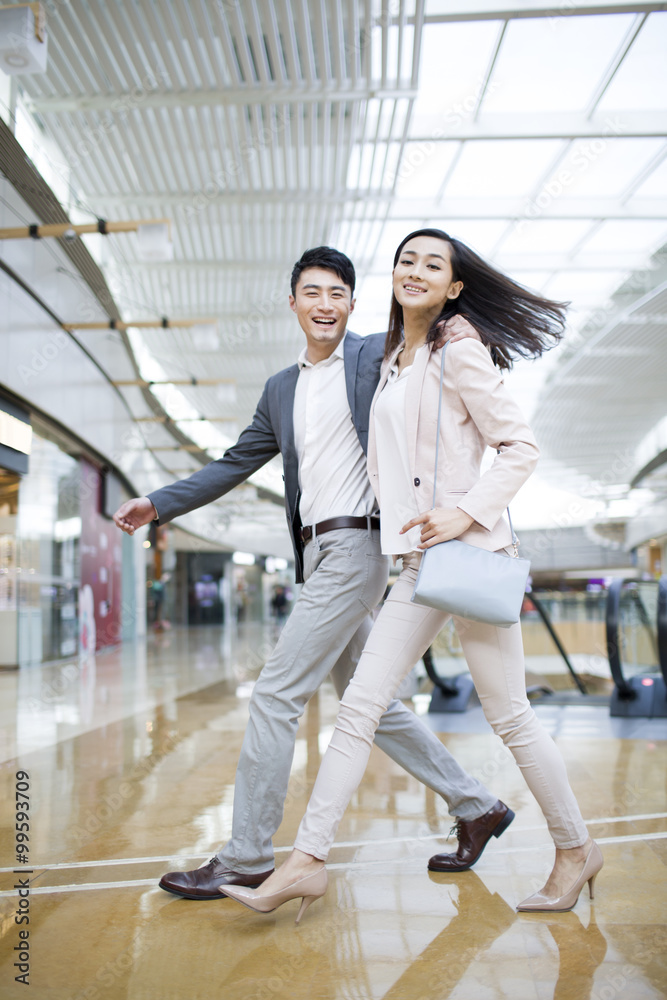 Young couple walking in shopping mall