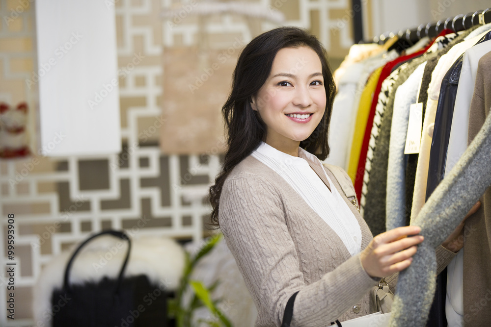 Young woman shopping in clothing store