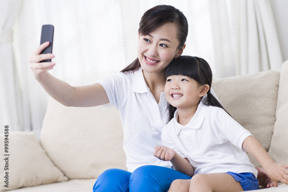 Mother and daughter taking self portrait