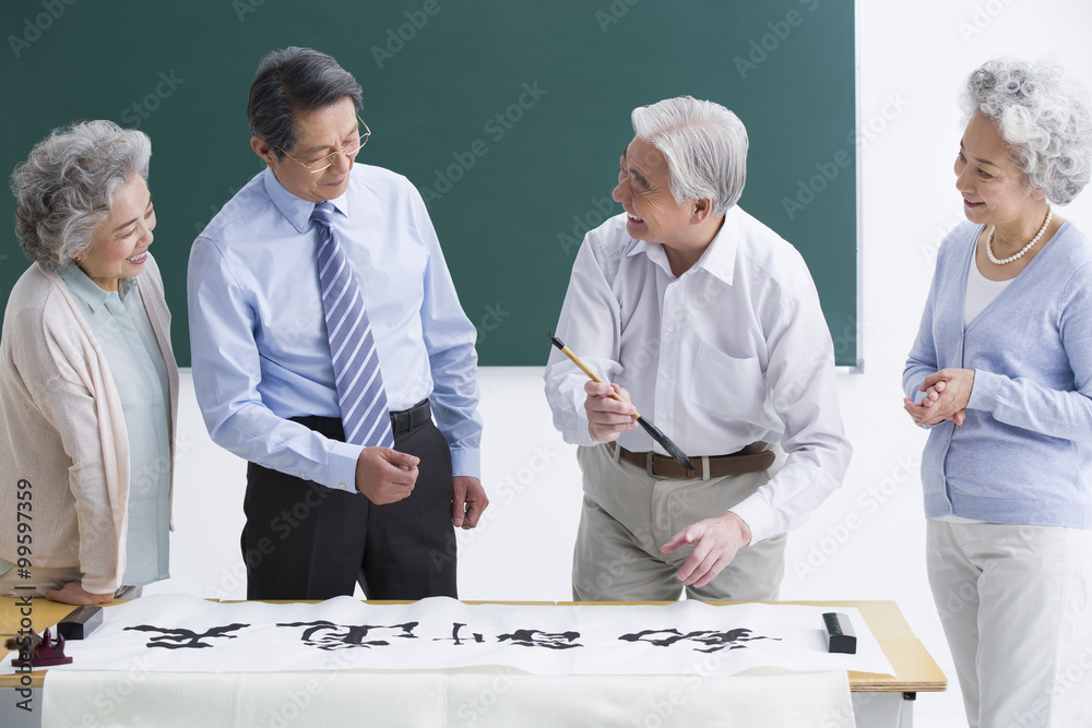 Senior adults having calligraphy class at school