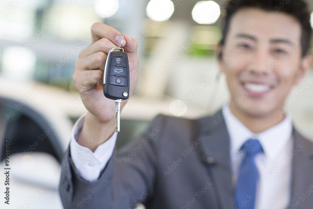 Salesman showing car key