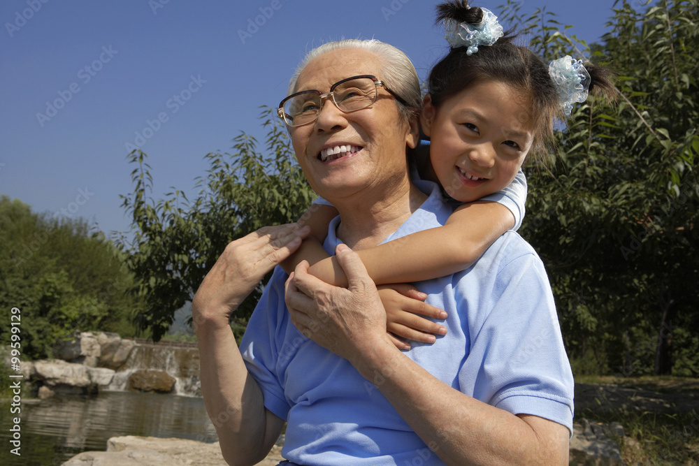 Grandfather Giving His Granddaughter Piggyback Ride, 