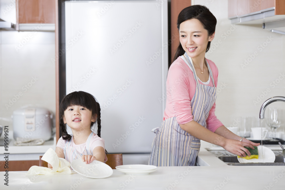 Mother and daughter washing dishes