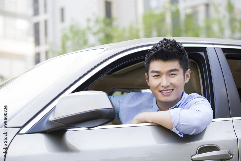 Young man driving car