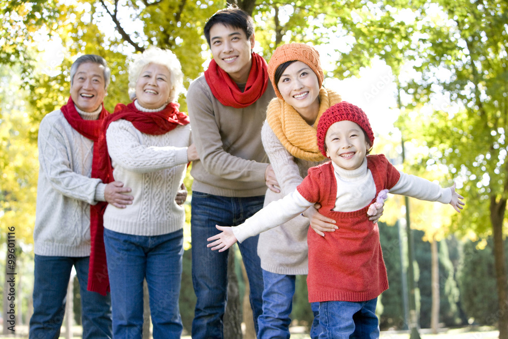 Three Generation Family Playing in a Park in Autumn