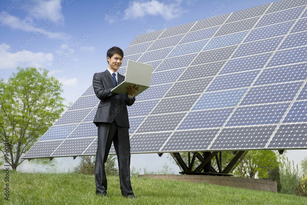 Portrait of a businessman in front of solar panels