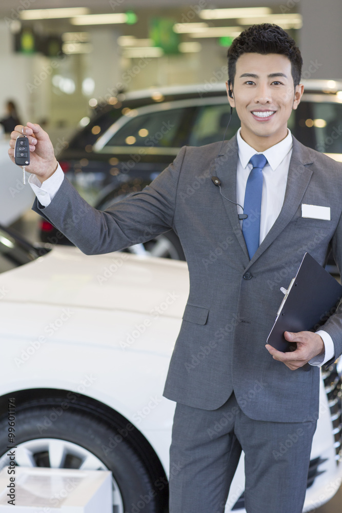 Salesman showing car key