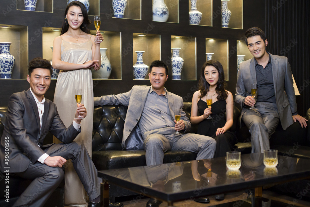 Cheerful adults drinking alcohol in luxury club