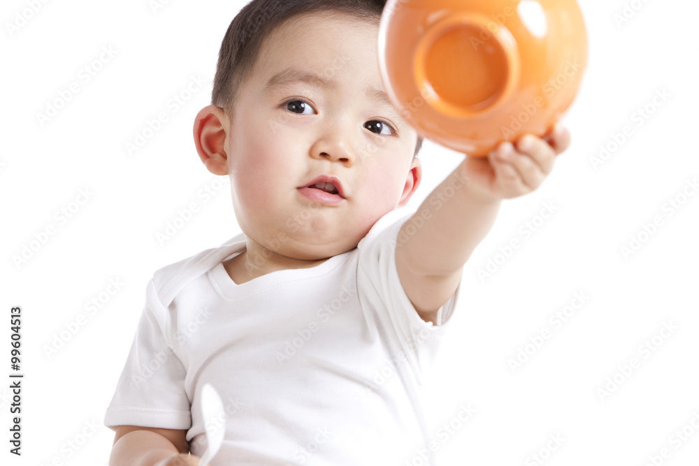 Cute baby boy with spoon and bowl